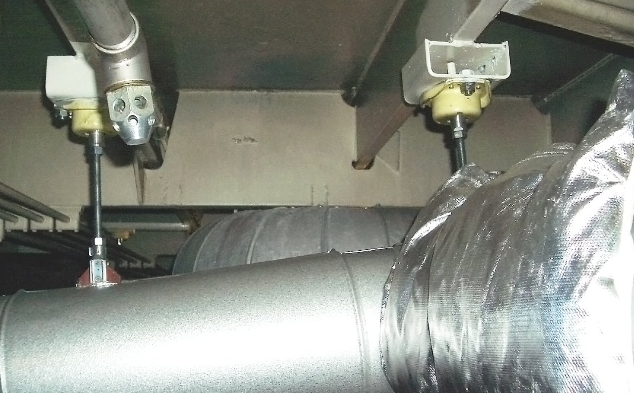 Exhaust pipe suspension using metal mounts VTCI to reduce vibrations and allow movement from thermal expansion.