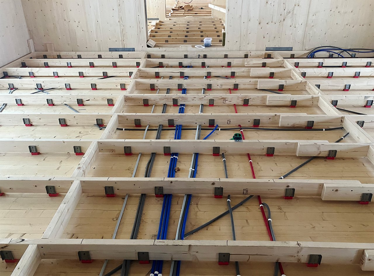 Image of Vibratec Flexible Floor Bracket in CLT-contruction. The VT-FFB is used to create a floating floor construction to reduce step and other impact sounds because of its splendid vibration isolating properties.