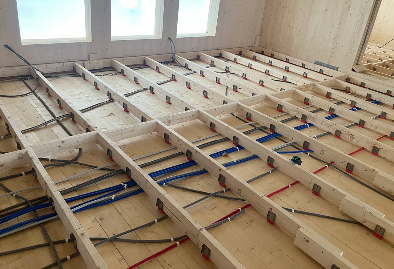 Image of Vibratec Flexible Floor Bracket in CLT-contruction. The VT-FFB is used to create a floating floor construction to reduce step and other impact sounds because of its splendid vibration isolating properties.